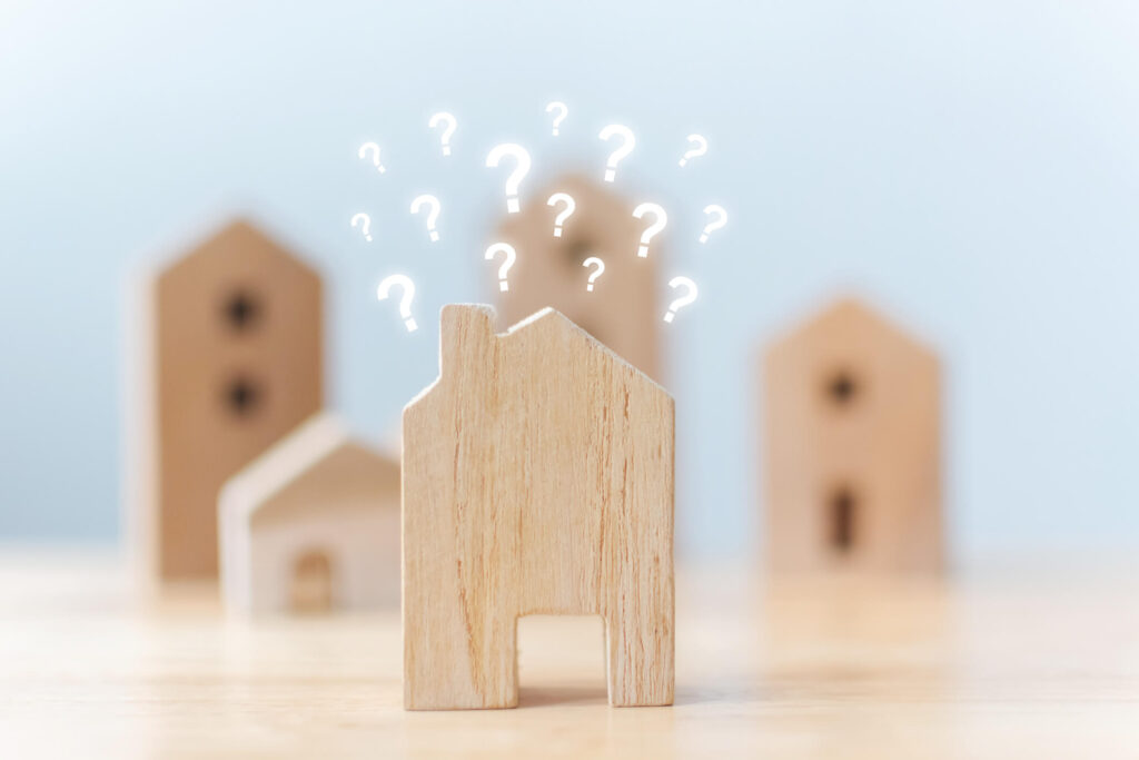 Learn the ways to finance your California rental property. Wooden Long Beach house with question marks above.