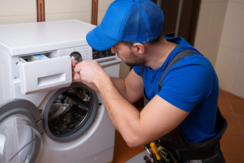 Repairman fixes rental property appliance in California